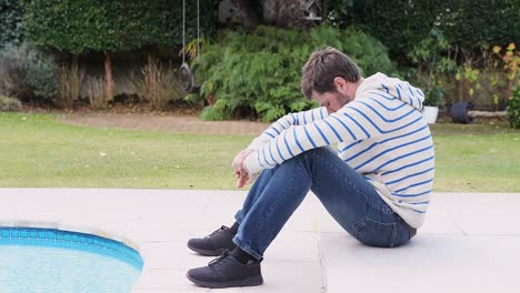 worried young man sitting near pool 4k 4k