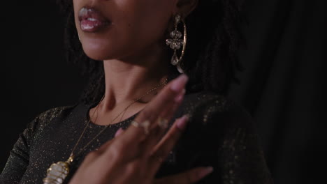 portrait shot of young sensual african american women with black background as camera pans down revealing body