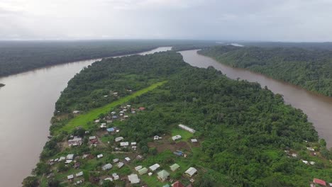 Aerial-drone-shot-of-remote-village-situated-along-the-river-in-South-America-between-Suriname-and-French-Guyana