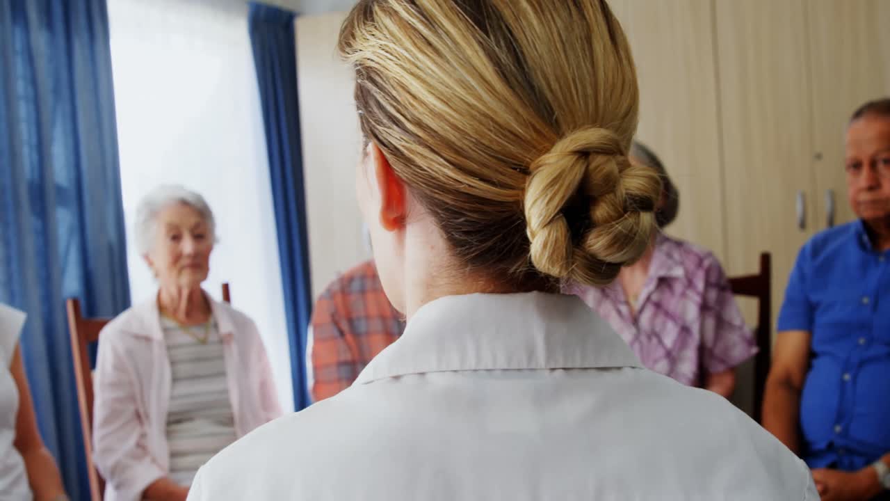 여성 의사가 노인들과 소통하고 있습니다. 4k