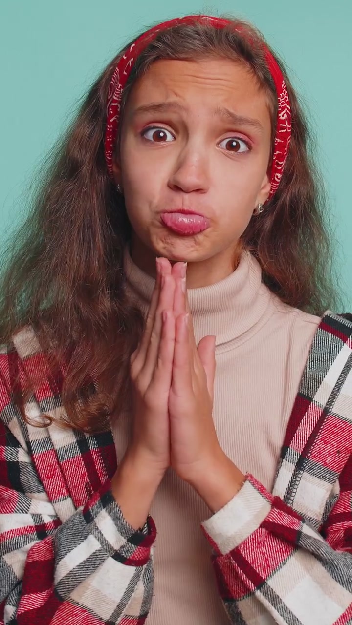 Child girl kid sincerely praying to god and looking up with pleading expression begging apology