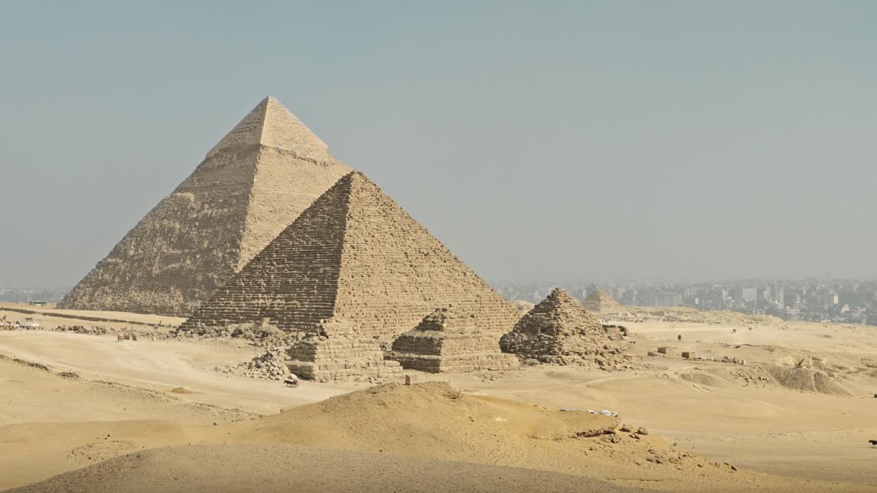 A panorama of the Giza Necropolis featuring the three principal pyramids built for Pharaohs Khufu, Khafre, and Menkaure, surrounded by the desert landscape