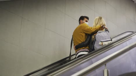 caucasian couple on the go wearing a coronavirus covid19 mask