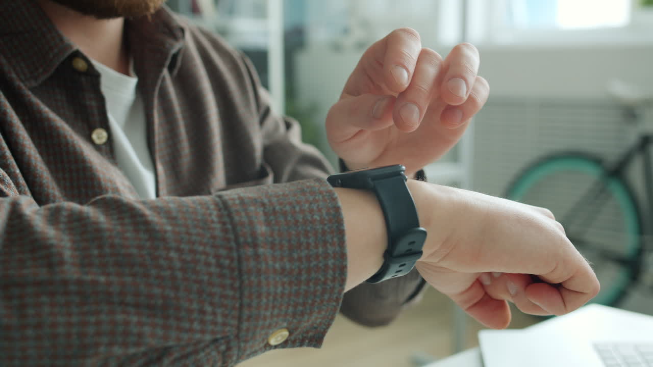 Man Checking Smartwatch in Office