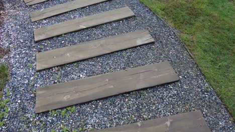 wooden path through a stone garden