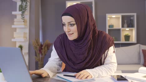 muslim business woman rejoices. working from home.