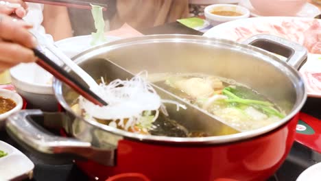 cooking and sharing hotpot meal in bangkok