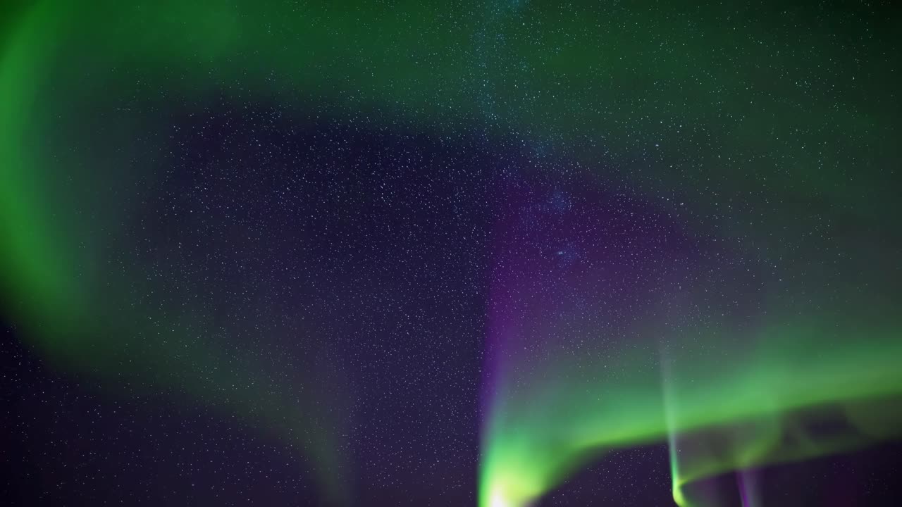 A mesmerizing video capturing the vibrant colors of the Northern Lights dancing across a starry sky