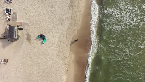 AERIAL:-Top-Shot-of-Couple-Walking-Together-in-Romantic-Mood-On-Golden-Hour-Near-Sea