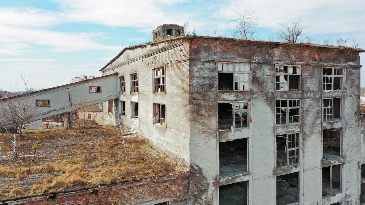Aerial view of an old factory ruin and broken windows. Old industrial building for demolition.