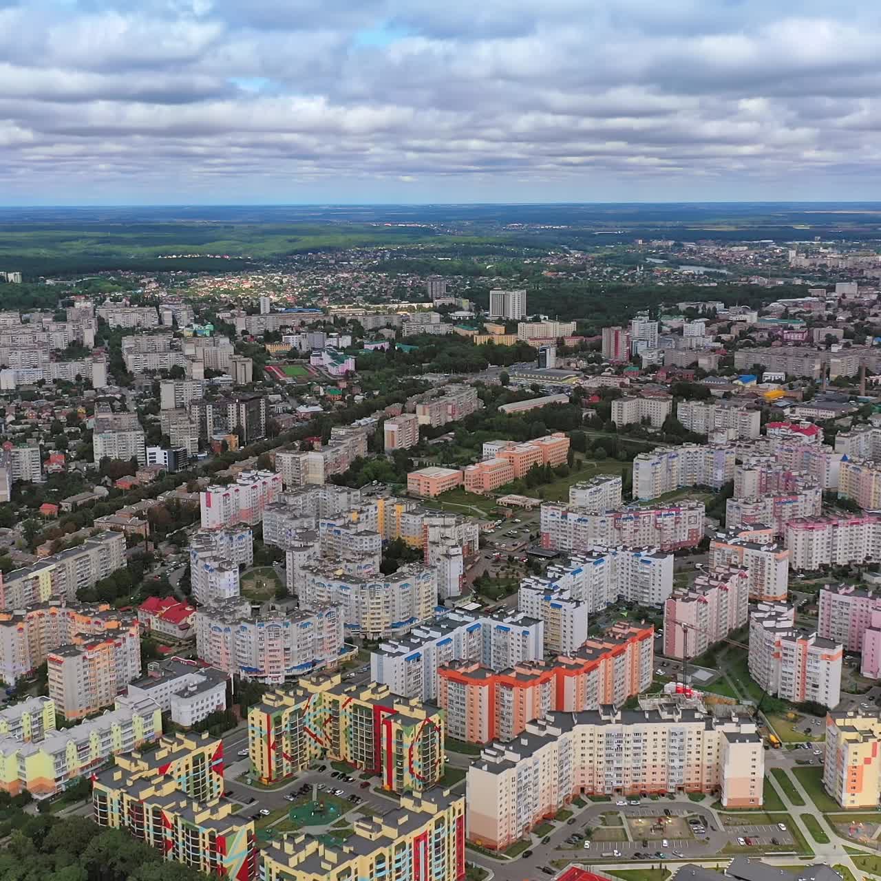 Urban background. Modern city with skyscrapers and traffic with cars. View from above on high-rise residential buildings. Aerial view