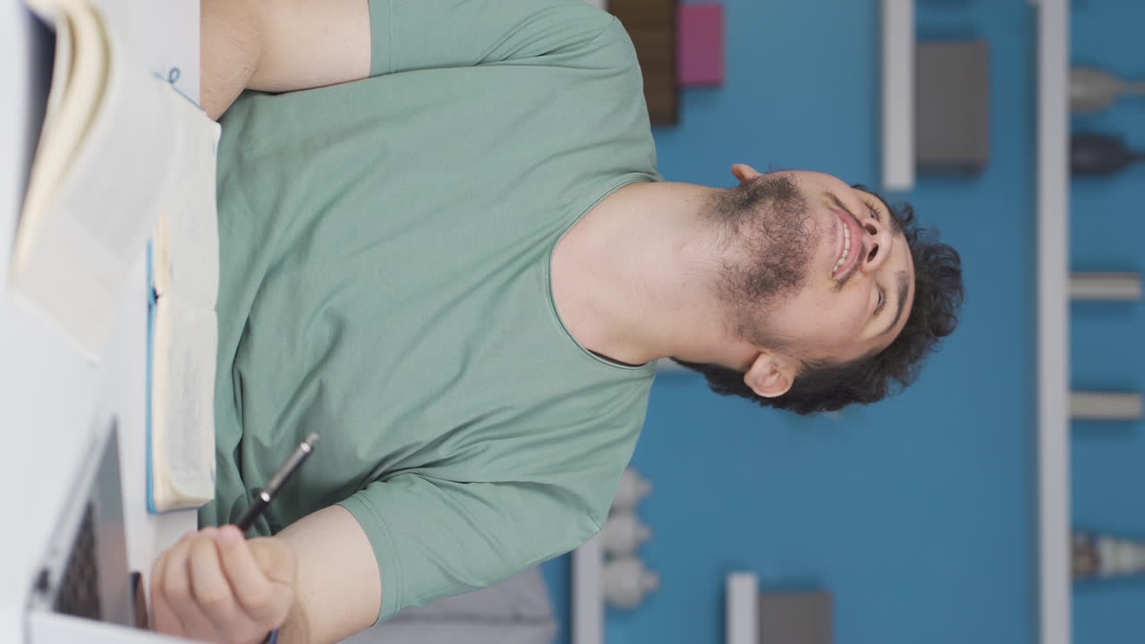 Vertical video of Rejoicing male student.