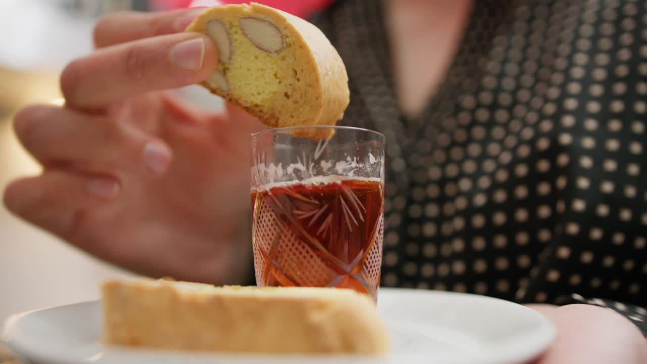 A Womans Hand Dips Biscuits Into Typical Indian Tea