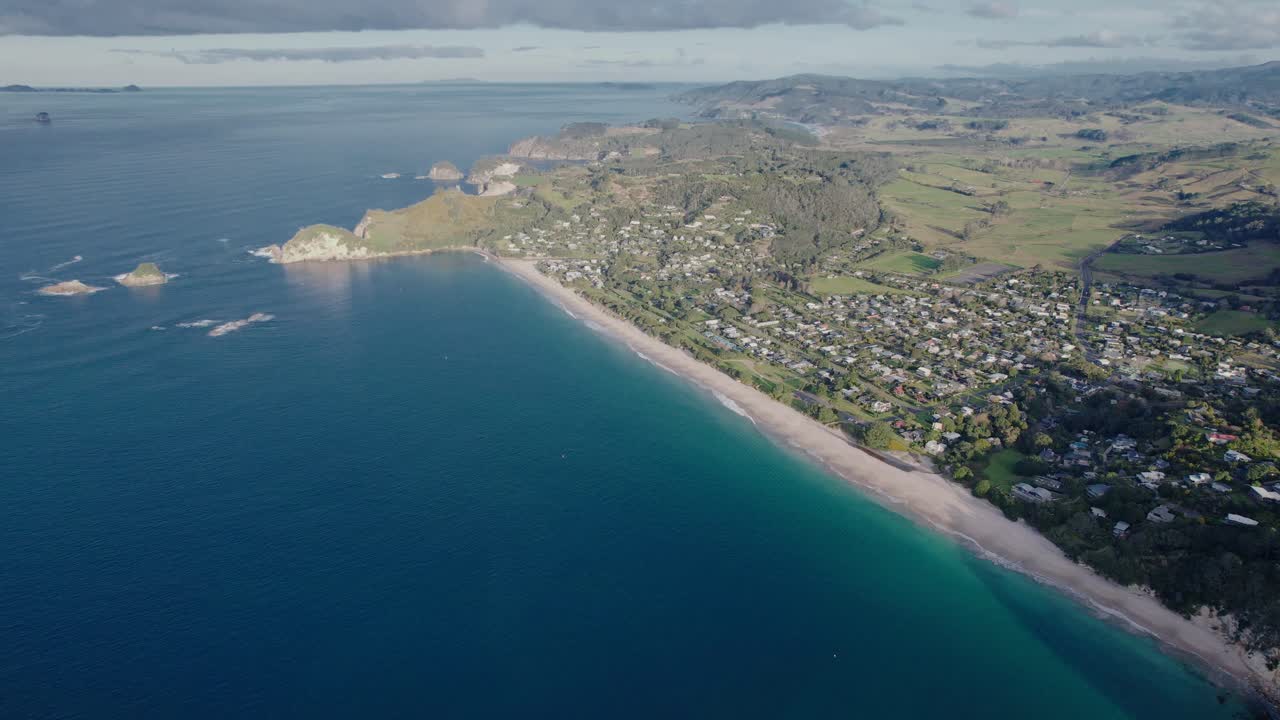 Aerial View of a Coastal Village and Beach