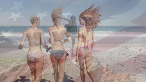 animation of flag of america, excited caucasian woman, female friends on bikini running into ocean