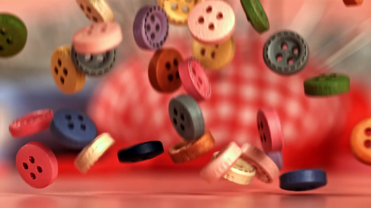 Bunte Knöpfe fallen und hüpfen in Zeitlupe.