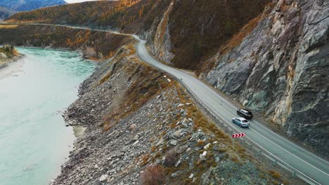 Scenic Mountain Road with Autumn Colors and River View