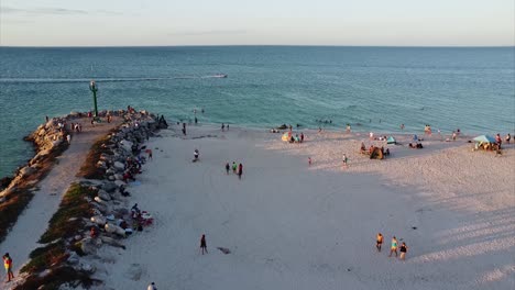 aerial view of crowded beach at sunset