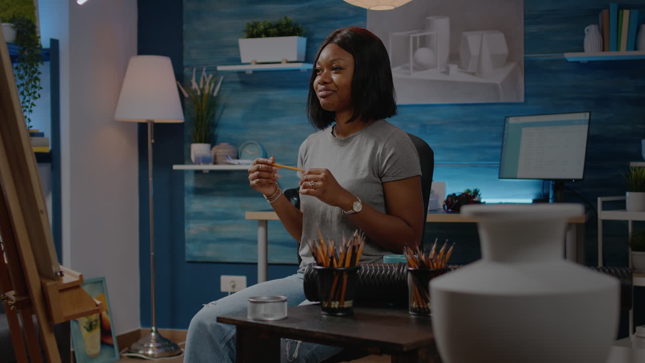 Black young artist working on vase drawing at home