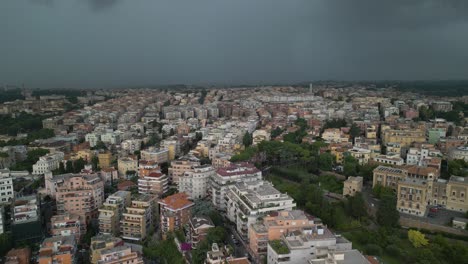 Aerial-drone-forward-moving-shot-of-dark-clouds-passing-by-over-residential-buildings-in-the-city-of-Rome,-Italy-on-a-stormy-day