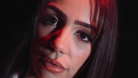 young beautiful woman with beautiful face, eyes and lips looks into the camera close up