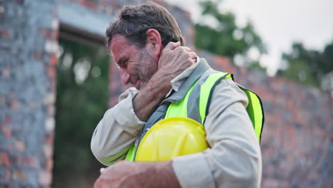 construction worker experiencing neck pain at a construction site