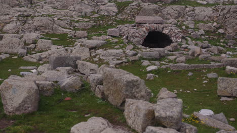 an ancient stone well in a field of stones in pergamum