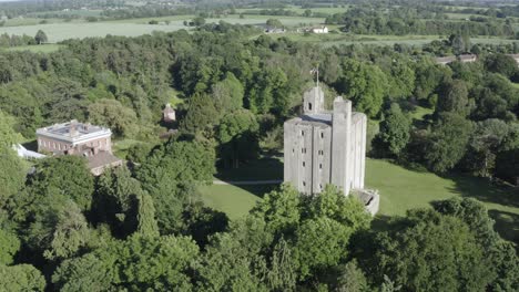 summery fields of green with a castle in the middle from an aerial point of view