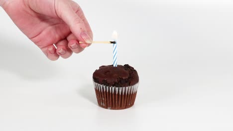 a sequence of lighting a candle on a cupcake