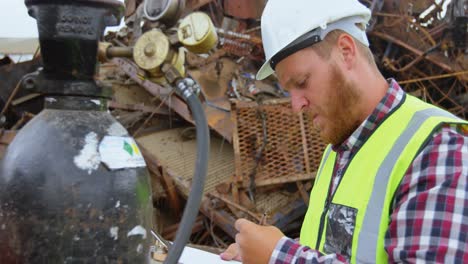 male worker examining gas cylinder 4k