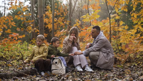 family sitting around a dead tree