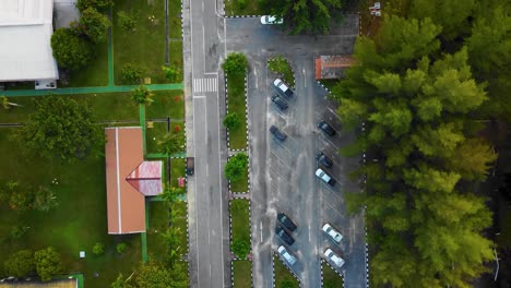 Cinematic-Drone-Footage-of-Palm-Oil-Mill-Effluent-residential-consists-of-buildings,-homes,-main-road-and-infrastructure-surrounded-by-palm-oil-trees-deforestation-located-in-Indonesia-in-full-HD