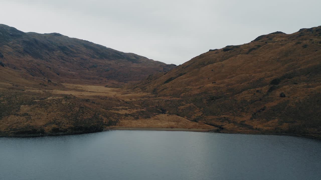 Aerial flight over small loch on the Isle of Mull, Scotland and the Scottish highlands. Western Hebrides.