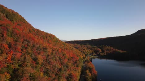 Beautiful-aerial-drone-footage-of-the-fall-leaves-on-and-around-Mount-Hor,-Mount-Pisgah,-and-Lake-Willoughby-during-peak-autumn-foliage-at-Willoughby-State-forest-in-Westmore,-Vermont