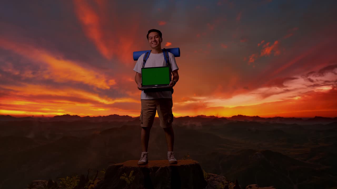 hombre con laptop en la montaña al atardecer