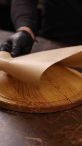 chef preparing pizza on a wooden board