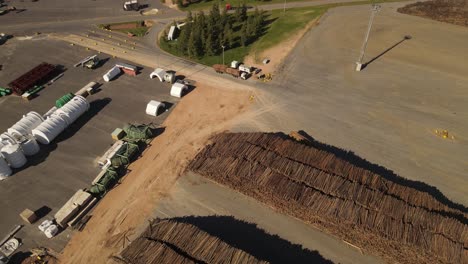 aerial top down showing truck transport with pile of trunks in paper mill factory