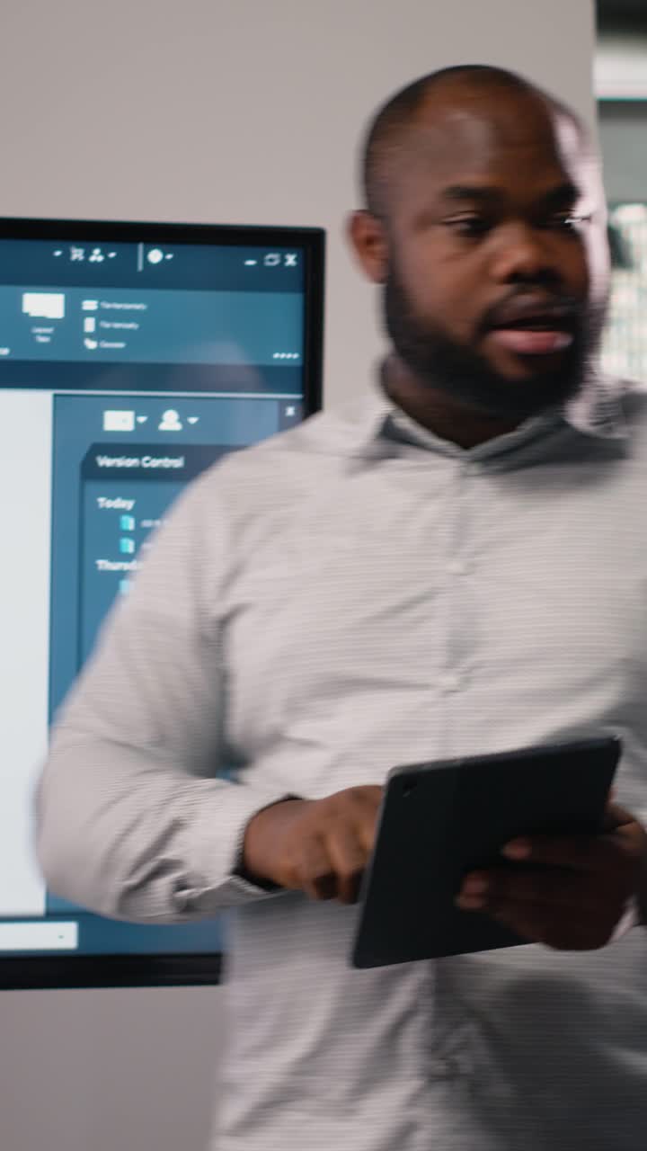 Vertical Video Black contractor reviewing architectural software and 3D models with his team