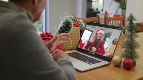 Caucasian-senior-man-on-video-call-with-adult-daughter-at-christmas-time