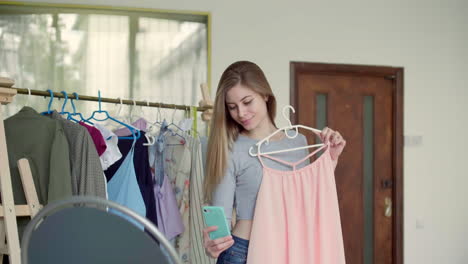 Girl-holding-a-dress-and-taking-selfie.