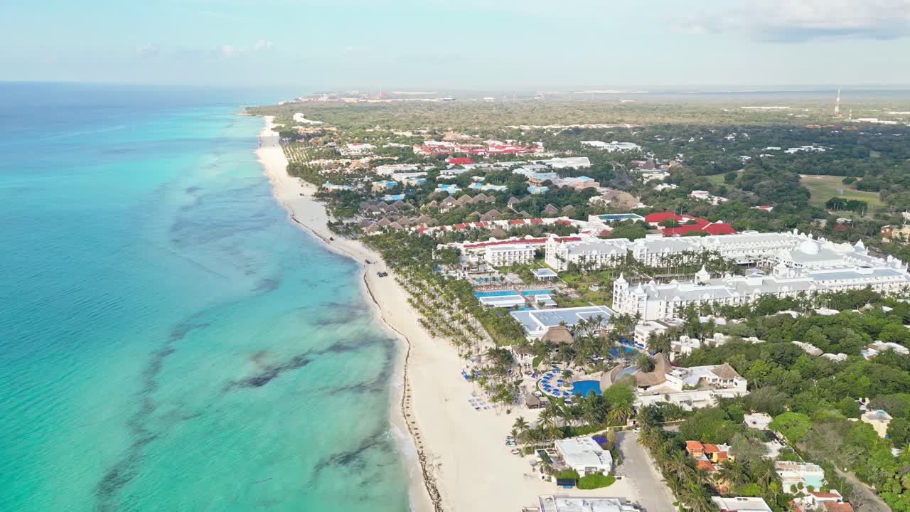 Beachfront resorts by turquoise sea in Playa del Carmen, sunny and tropical vibe