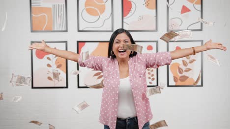 indian woman throwing money in air