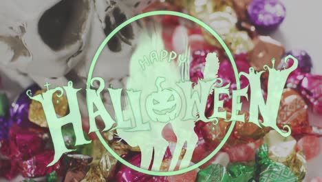 happy halloween text banner with pumpkin icon against close up of halloween candies on white surface