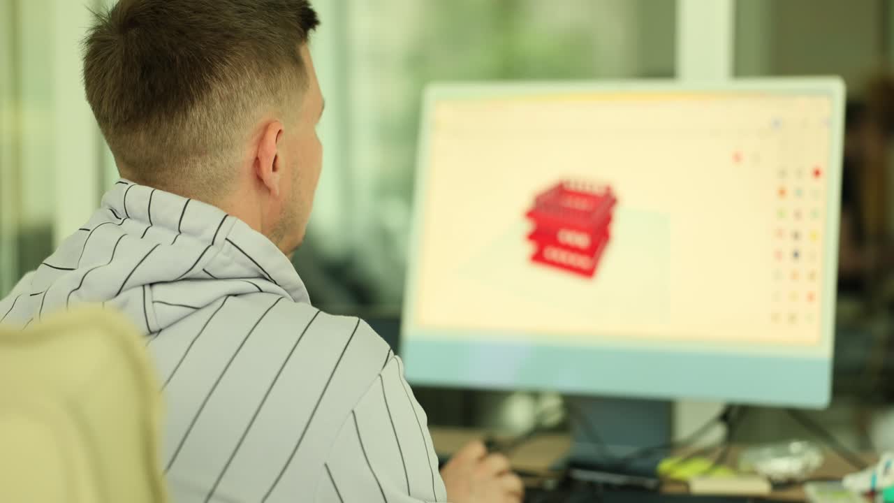 Man designing a 3D model on a computer