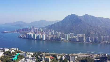 densely populated and modern apartments of ma on shan with the high mountains in the background in the beautiful asian nature in hong kong on a sunny day