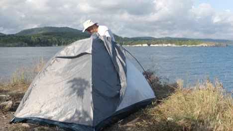 camper man dismantling tent