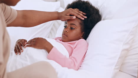 Mother,-child-and-hands-on-forehead-in-bed