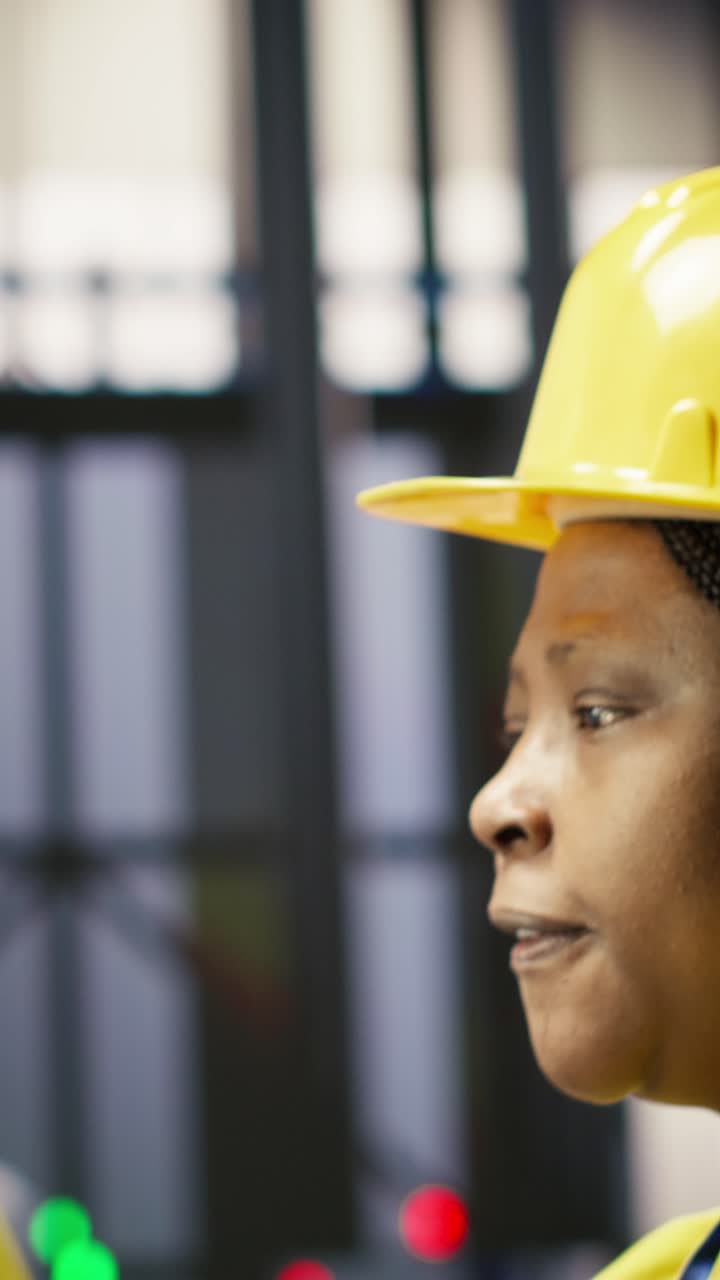 Vertical video Manager oversees work done by worker in smart factory, ensuring quality control