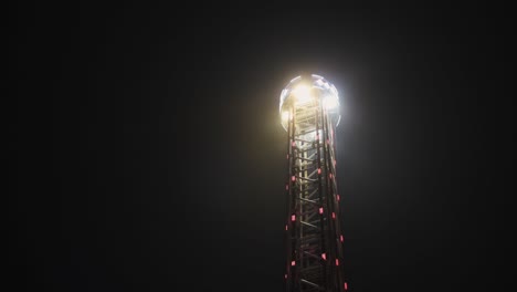 drop tower ride in night amusement park