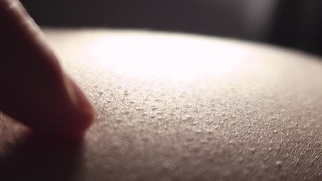 close-up of a finger touching human skin texture